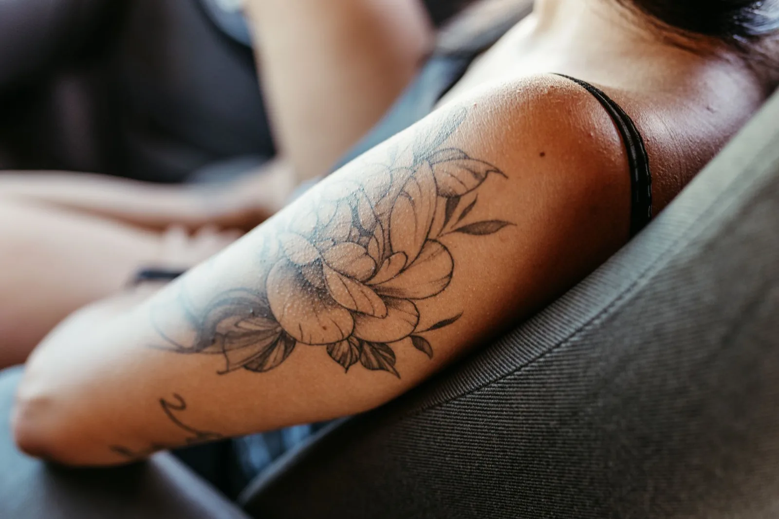 Floral tattoo on a woman's upper arm