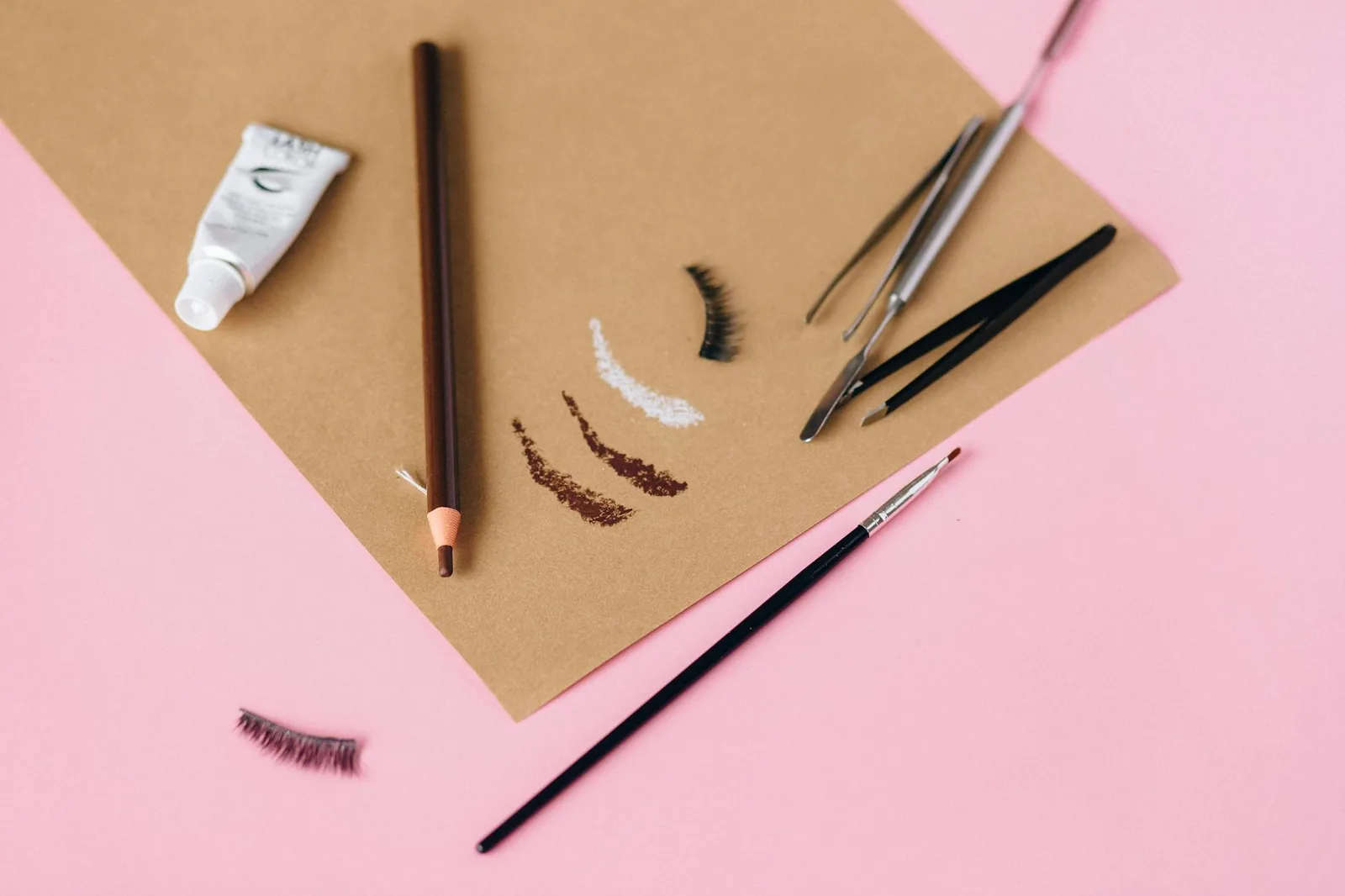 A collection of eyebrow makeup tools and cosmetics arranged for beauty styling.